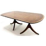 Regency style cross-banded mahogany twin pedestal extending dining table