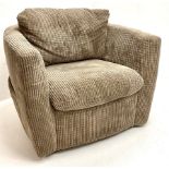 Swivel tub shaped armchair upholstered in jumbo cord fabric