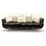 Grande four seat sofa upholstered in patterned fabric with contrasting scatter cushions