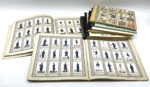 Seven albums containing German cigarette cards of military interest by Waldorf Astoria etc including