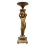 Italian carved lime wood torchère, the column modelled as a putto with arms raised supporting a