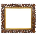 20th century rectangular wall mirror in walnut frame carved and pierced with foliage and berry decor