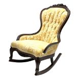 Early 20th century rocking chair with raised floral and foliate carving to frame