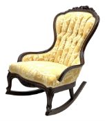 Early 20th century rocking chair with raised floral and foliate carving to frame