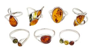 Seven silver amber stone set rings