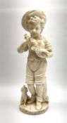 A Victorian alabaster figure modelled as a young boy holding bird