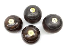 Four early 20th century lawn bowl balls