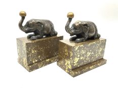 A pair of bronzed bookends