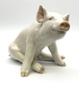 A Royal Copenhagen figure modelled as a seated pig 414