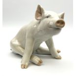 A Royal Copenhagen figure modelled as a seated pig 414