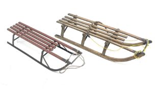 Two vintage davos wooden sledges with metal runners