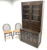 Ercol dark elm fall front cocktail display cabinet and two stick back chairs