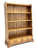 Late 20th century oak open waterfall bookcase with two base drawers