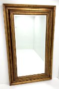 Large rectangular swept gilt framed bevel edge mirror