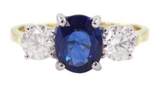 18ct gold three stone oval Ceylon sapphire and round brilliant cut diamond ring