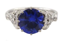 White gold round synthetic sapphire and diamond ring