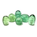 Six Victorian green glass dump paperweights