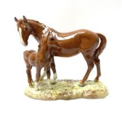 A Beswick model of a chestnut mare and foal on naturalistic base