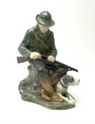 A Royal Copenhagen figure of a Huntsman and his dog modelled by Christian Thomsen No 1087