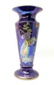 A Maling vase decorated with cranes upon an iridescent purple ground