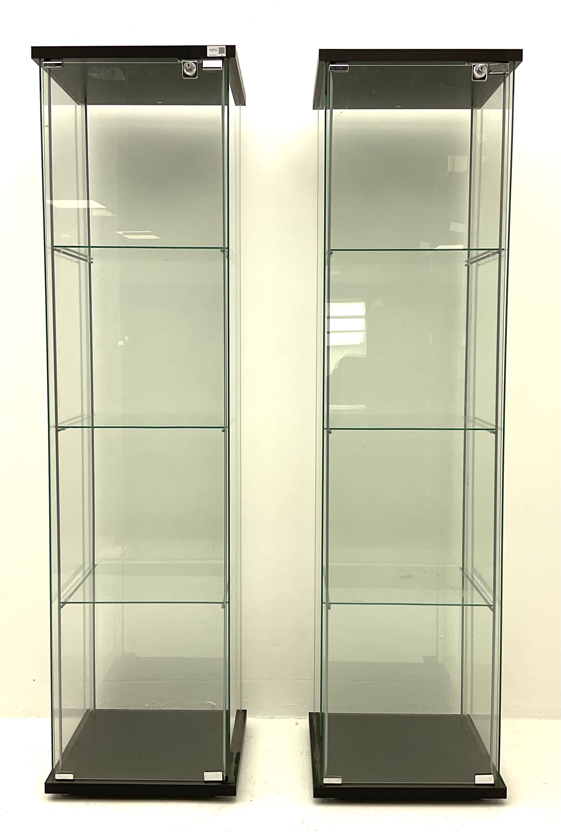 Pair of floor-standing four sided glass display cabinet