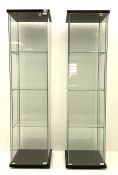 Pair of floor-standing four sided glass display cabinet