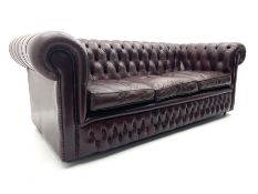 Three seat Chesterfield sofa upholstered in deeply buttoned burgundy leather