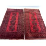 Two similar mid 20th century Afghan Bokhara red ground rugs