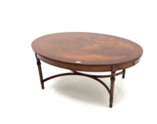 Cross banded mahogany oval coffee table