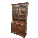 Late Victorian mahogany glazed bookcase on cupboard