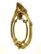 Ornate gilt framed oval wall mirror and a small rectangular wall mirror