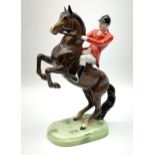 A Beswick model of a huntsman on rearing horse