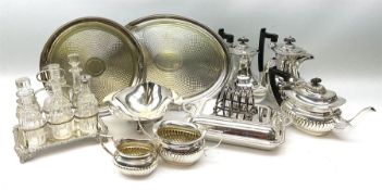 A silver plated six bottle cruet stand