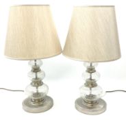 A pair of crackle glass table lamps each of three spheres