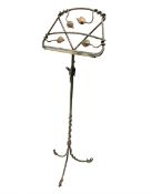 A wrought iron adjustable music stand