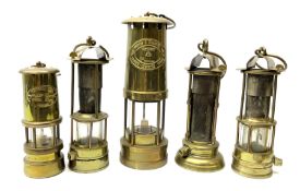 A collection of five mining lamps