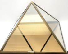 A large brass framed glass pyramid vitrine with gold tinted mirrored base