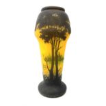 Reproduction Daum Nancy art nouveau style overlay and cut glass vase decorated with woodland and a