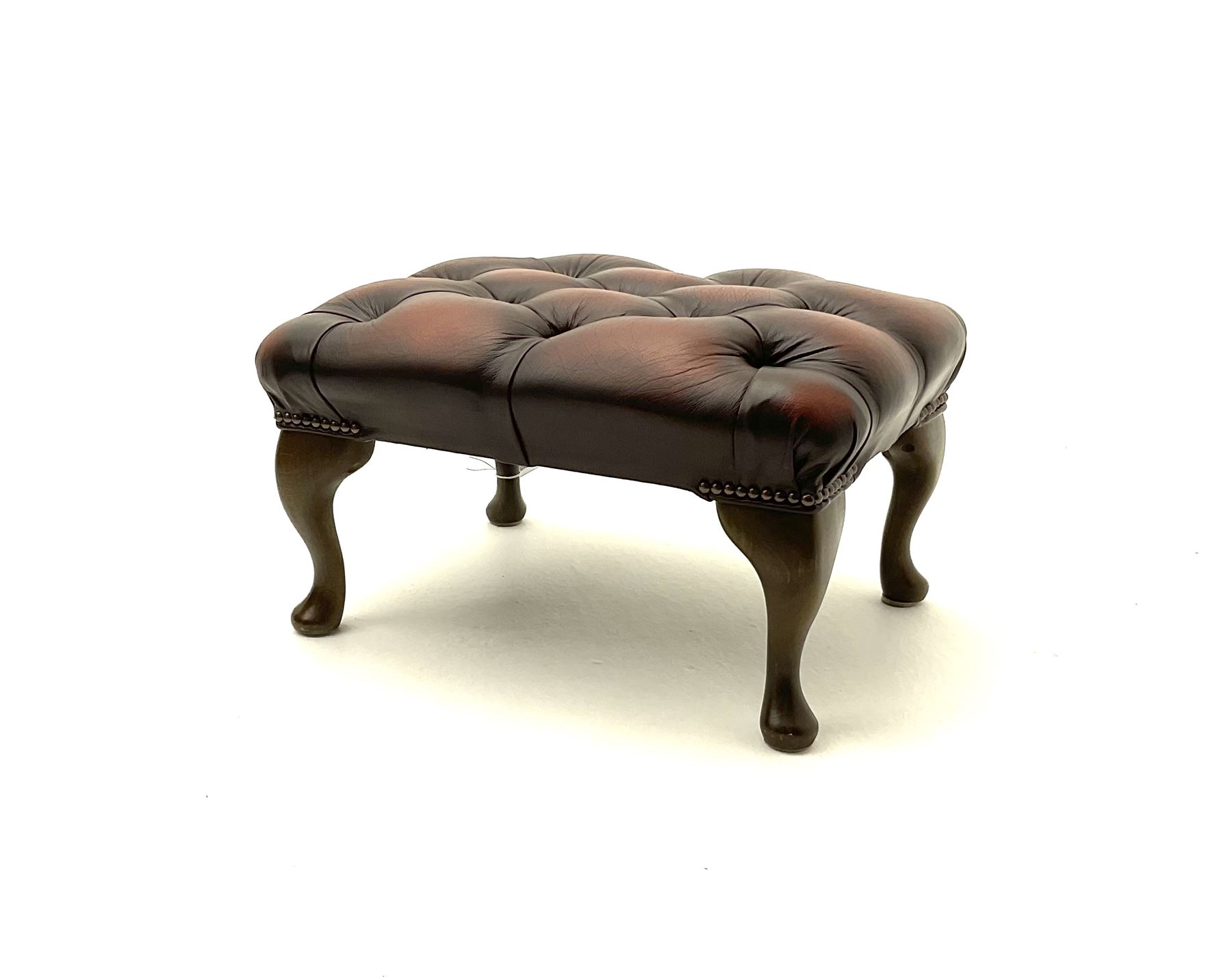 Rectangular studded footstool upholstered in deep buttoned brown leather