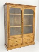 Edwardian oak glazed bookcase with drawer