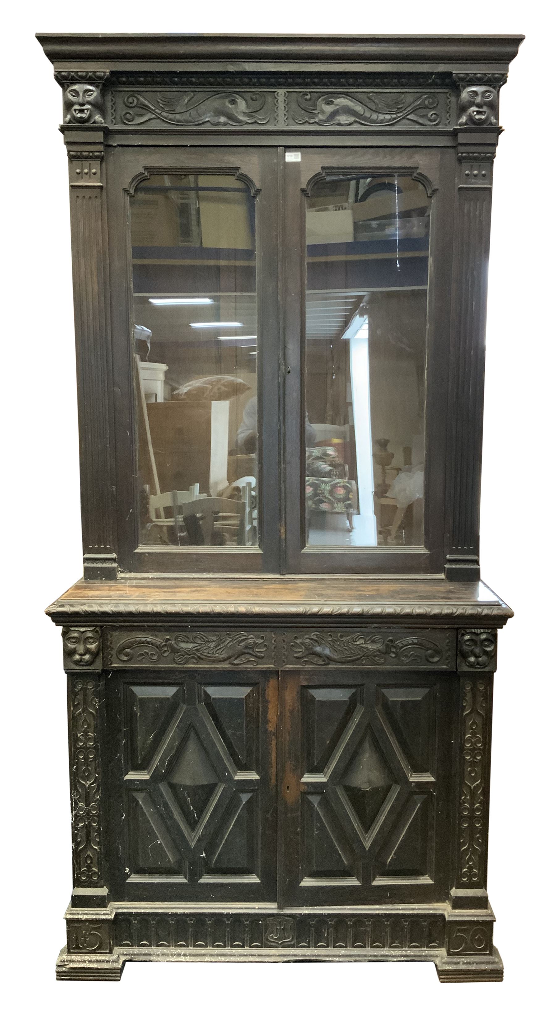 19th century continental carved oak bookcase on cupboard