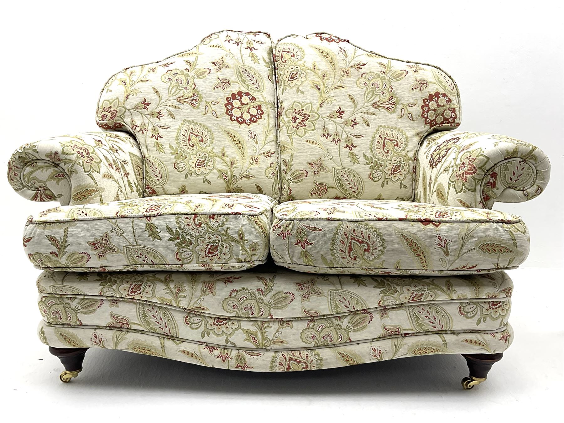 Pair traditional shaped two seat sofas upholstered in floral pattern and cream ground fabric