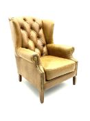 Georgian style wing back armchair upholstered in buttoned and studded tan leather