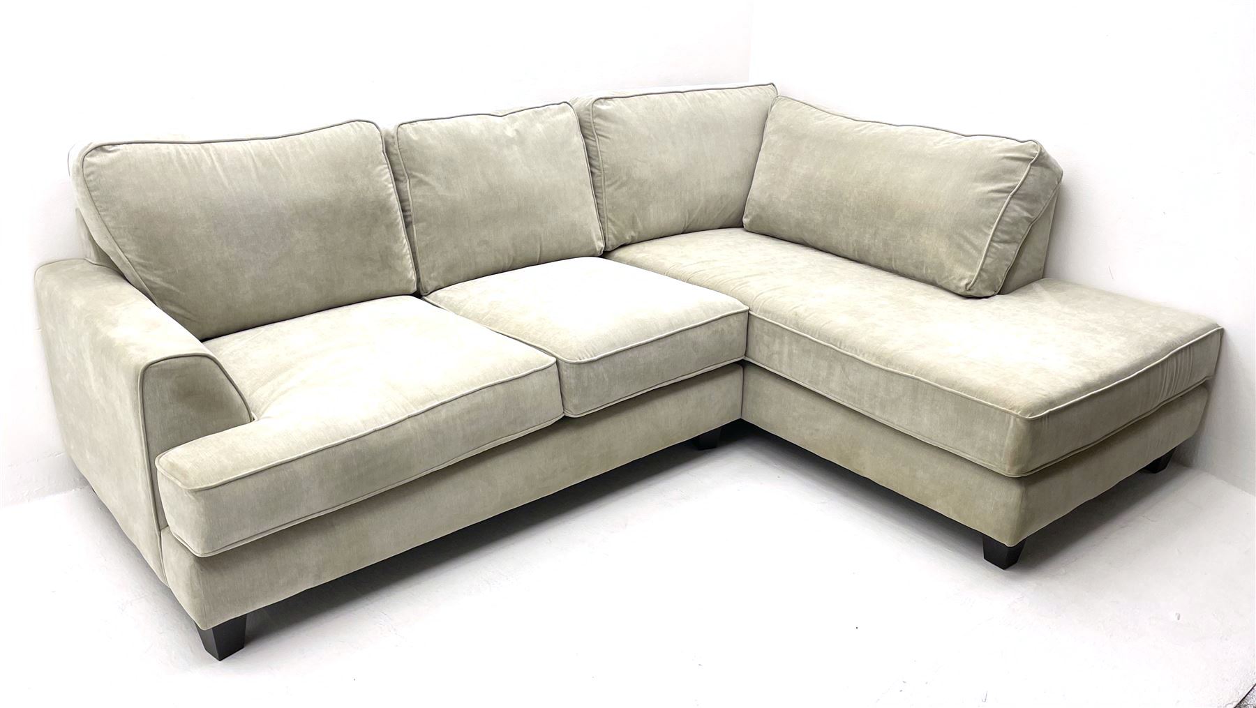 Corner sofa upholstered in light grey fabric