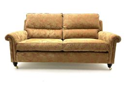 Duresta two seat sofa upholstered in a dark beige floral patterned fabric