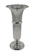 Silver trumpet shaped vase with wide flared rim and cast scroll decoration