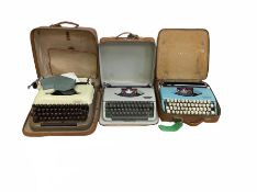 Three vintage portable typewriters comprising Olympia Splendid 99