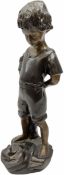 Bronze figure of a young boy standing pensively looking at a frog on a rock by his feet H39cm