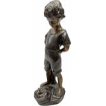 Bronze figure of a young boy standing pensively looking at a frog on a rock by his feet H39cm