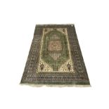 Persian design green and beige ground carpet